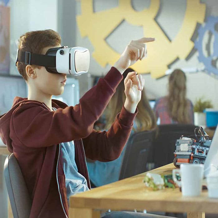 Student in a future classroom using VR goggles